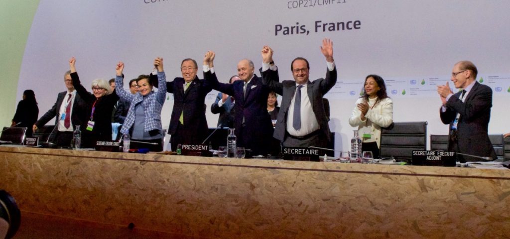 French_Foreign_Minister,_UN_Secretary-General_Ban,_and_French_President_Hollande_Raise_Their_Hands_After_Representatives_of_196_Countries_Approved_a_Sweeping_Environmental_Agreement_at_COP21_in_Paris_(23076185424)