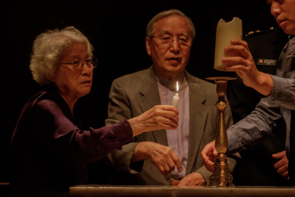 A candle is lit to honor families divided by the Korean War
